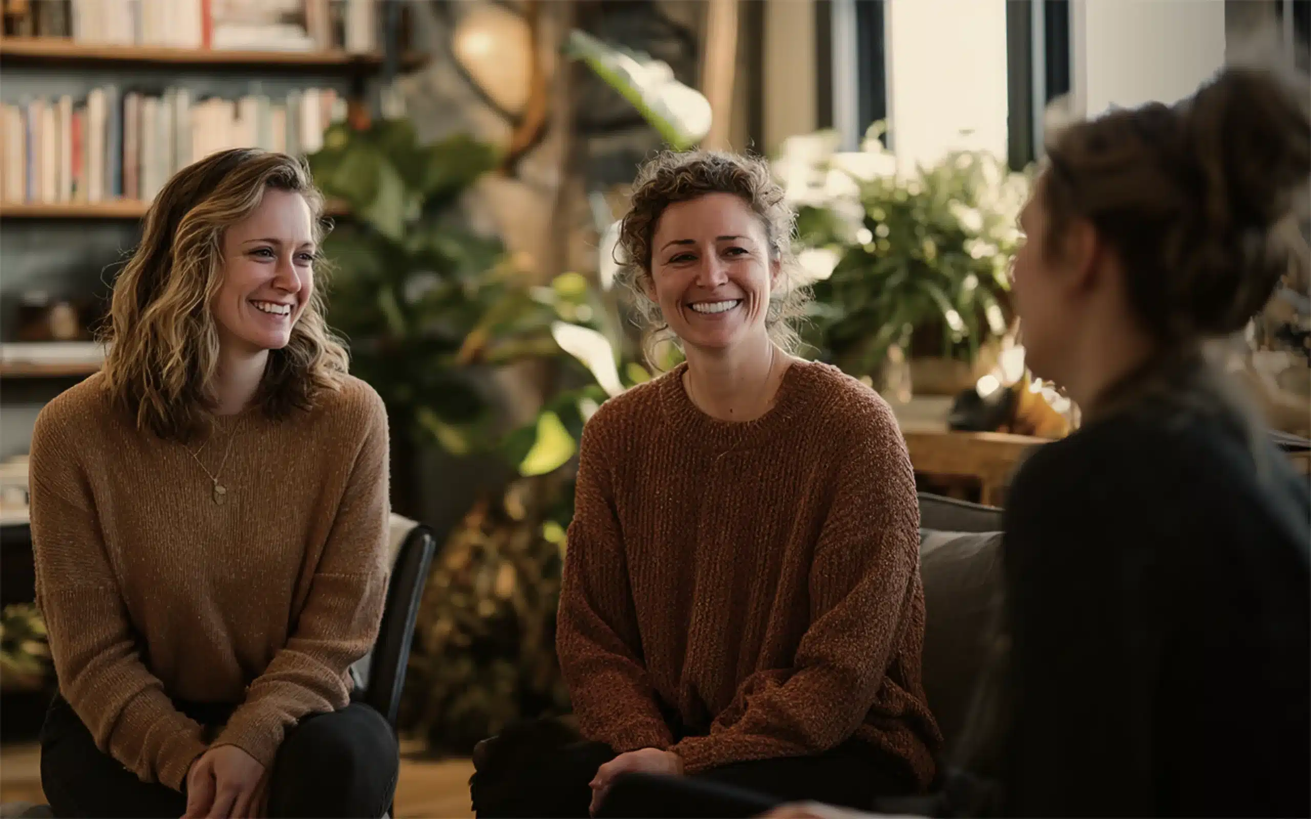 Warm, welcoming TherapyHive common space where people converse.