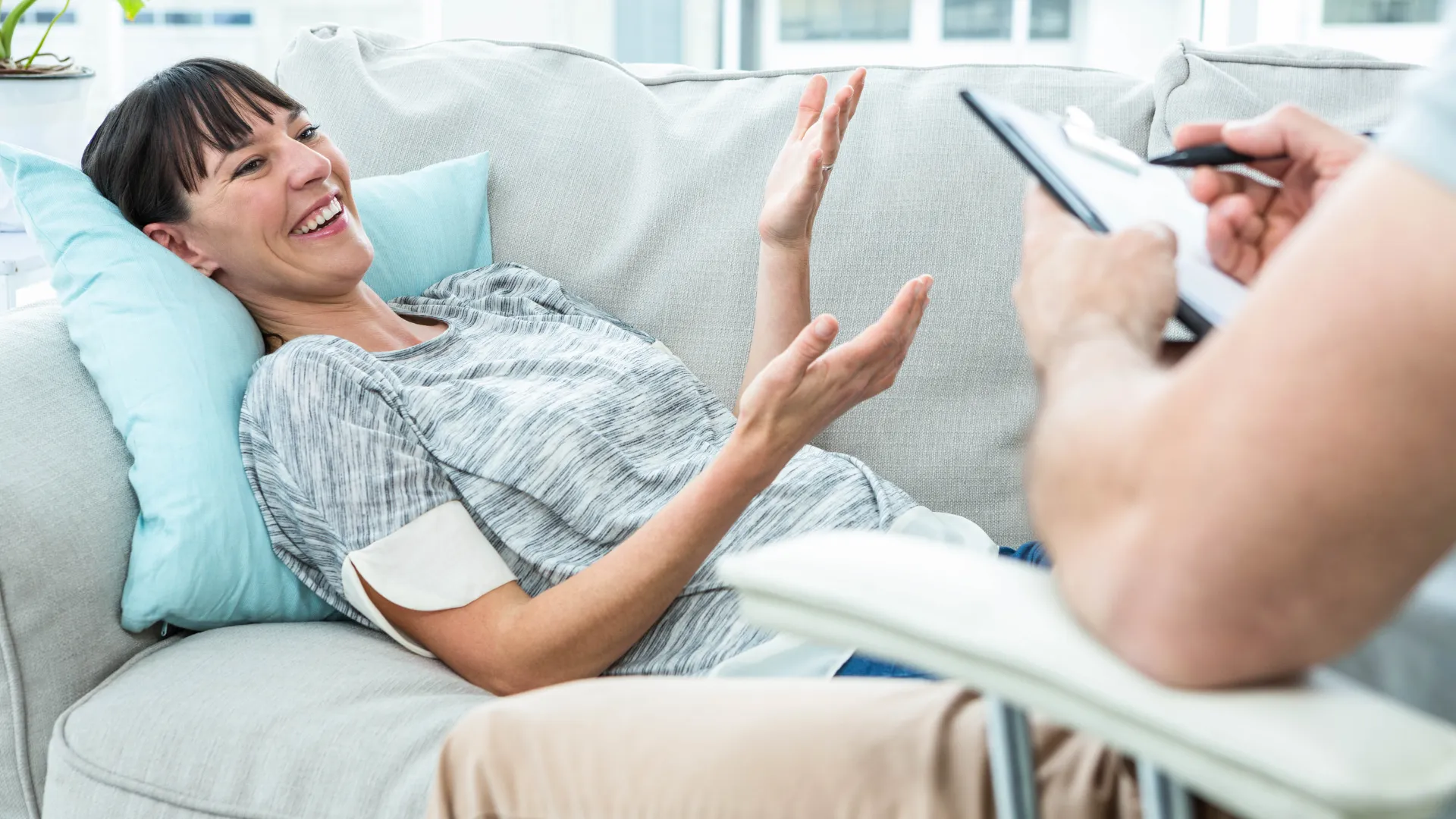 Woman laughing during therapy session.