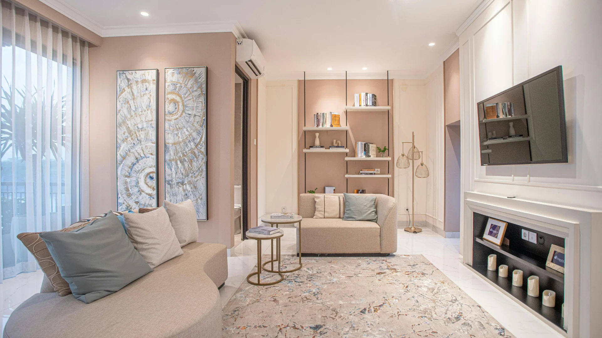 A cozy living room featuring a fireplace and a television, with comfortable seating arranged around the space.