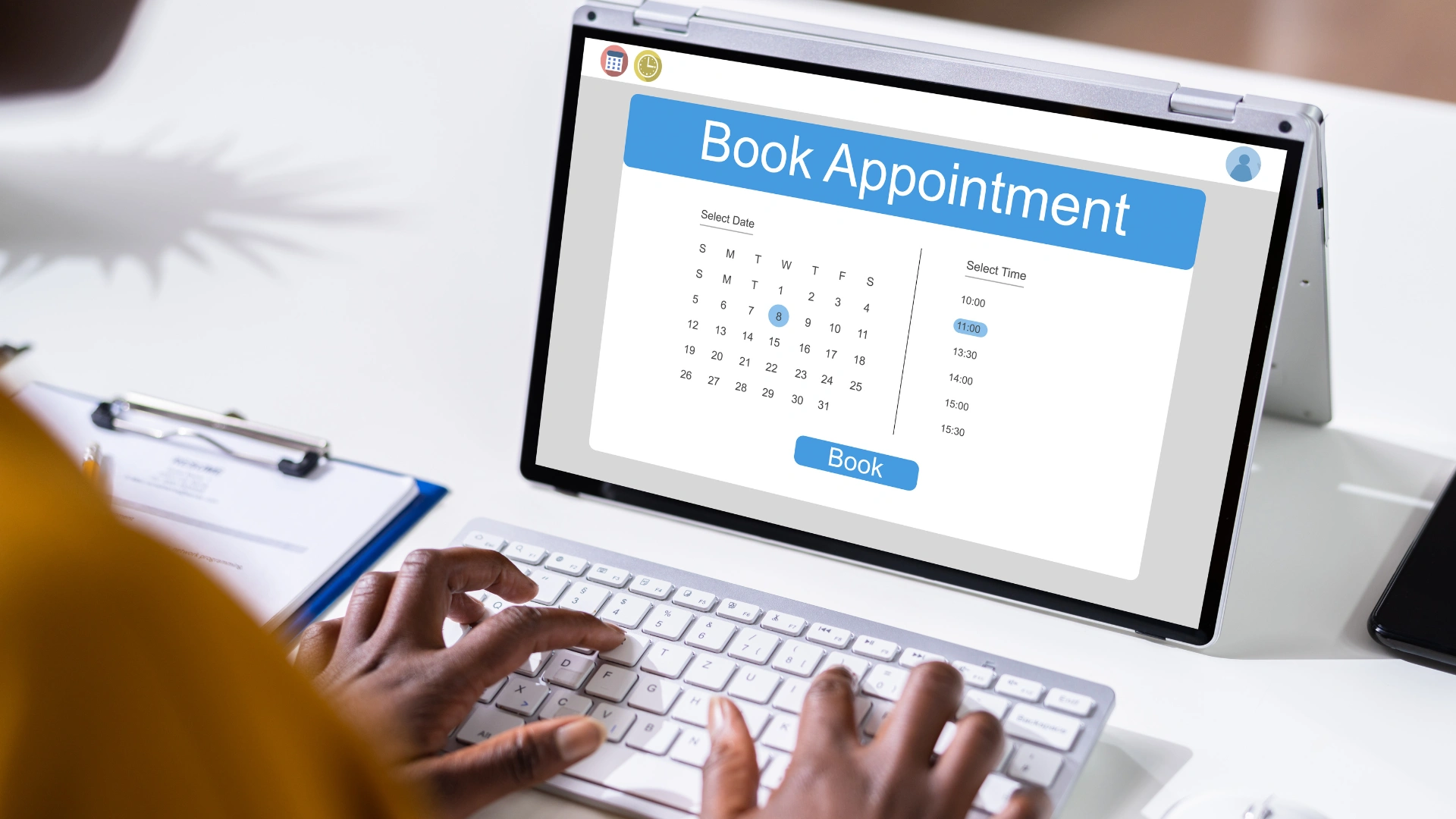 A person booking an appointment on a laptop, with a calendar and scheduling interface visible on the screen.